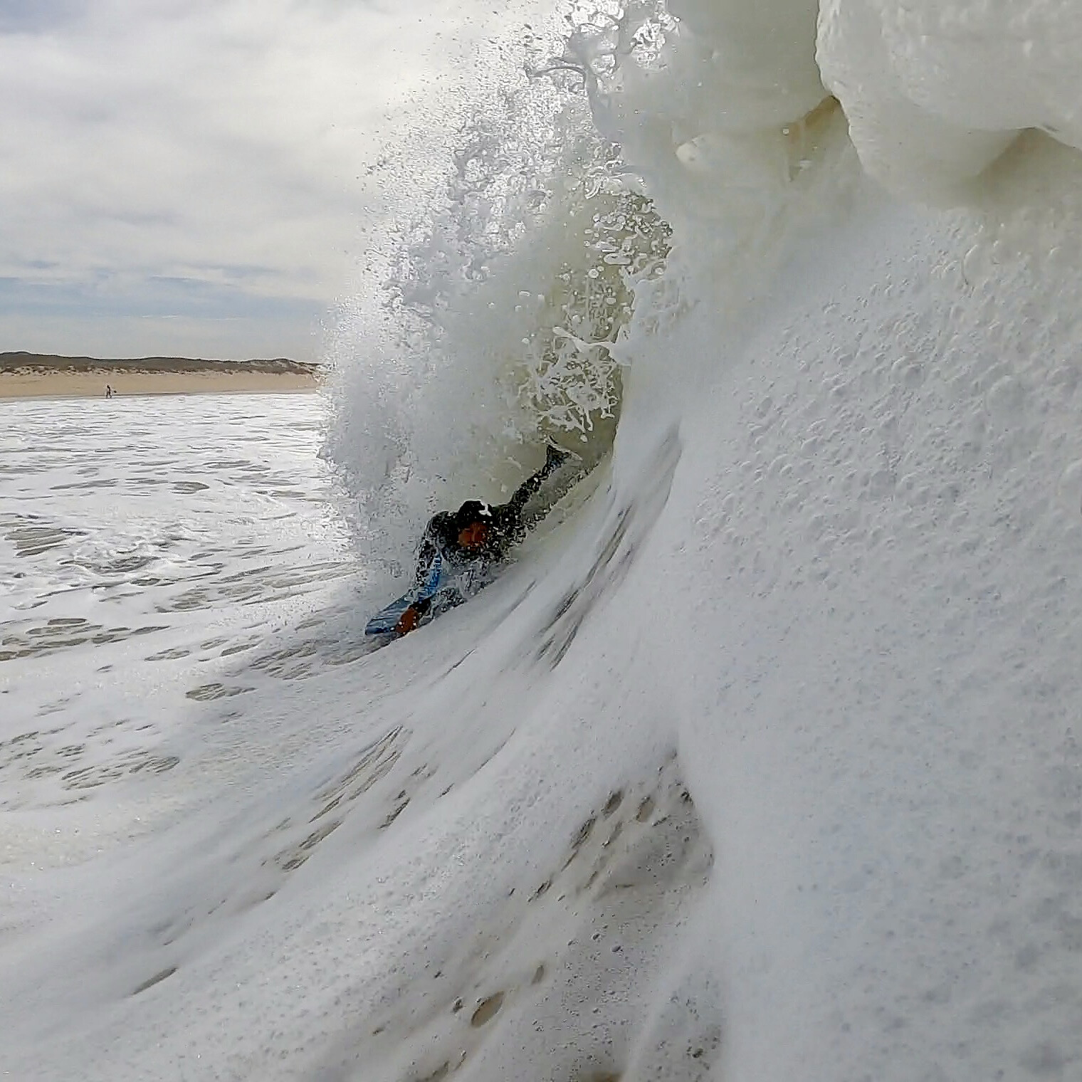 Bodyboarder inside a foamy barrel
