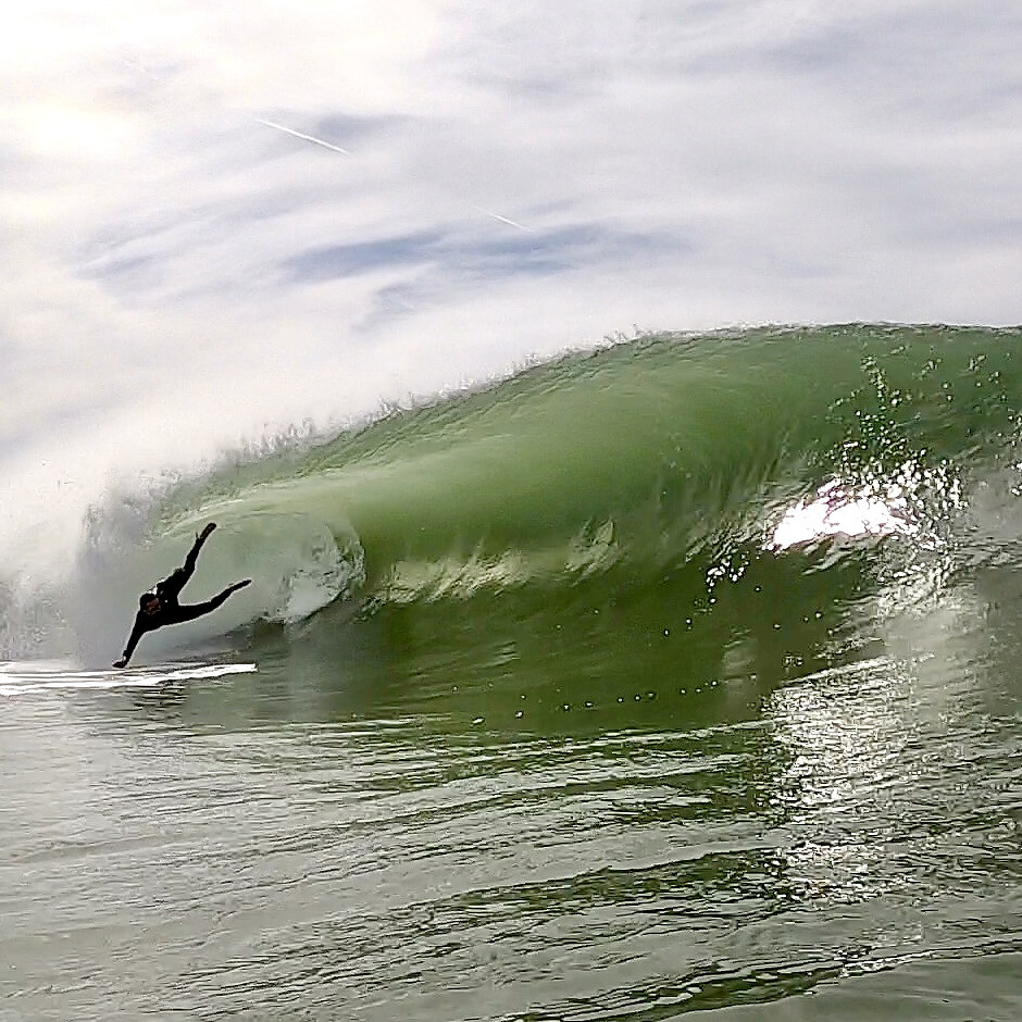 Surfer wiping out in front of a barrel