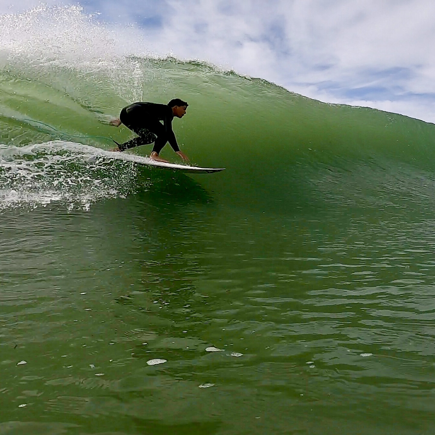 Surfer doing a bottom turn